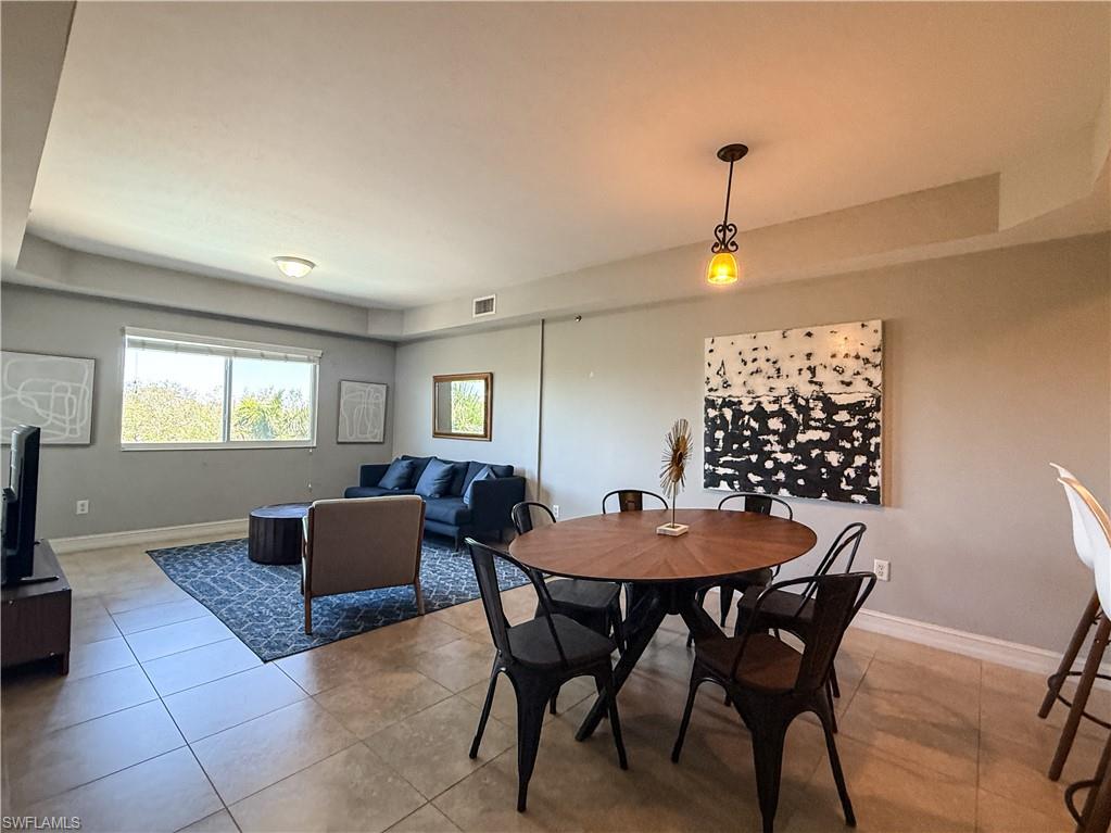 1100 Pine Ridge Road, Unit B405 Naples, FL 34108 - Photo 21 of 43 a view of a dining room with furniture