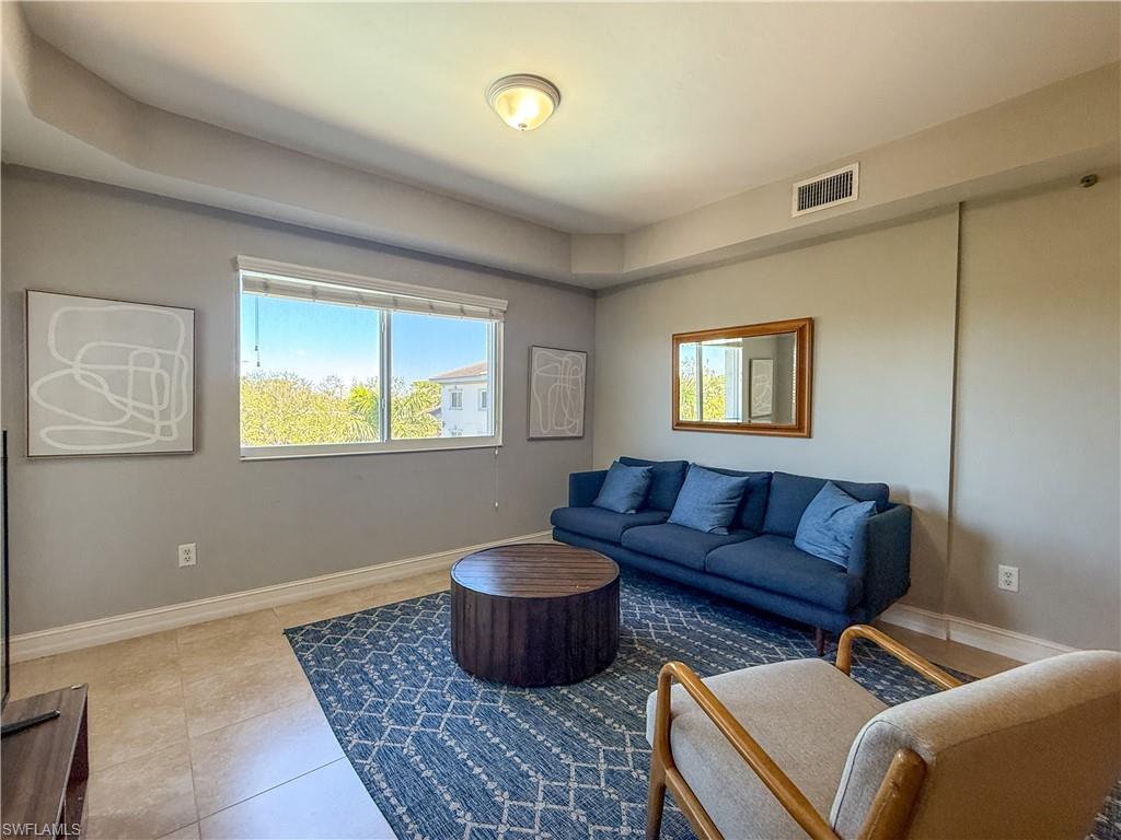 1100 Pine Ridge Road, Unit B405 Naples, FL 34108 - Photo 22 of 43 a living room with furniture and a window
