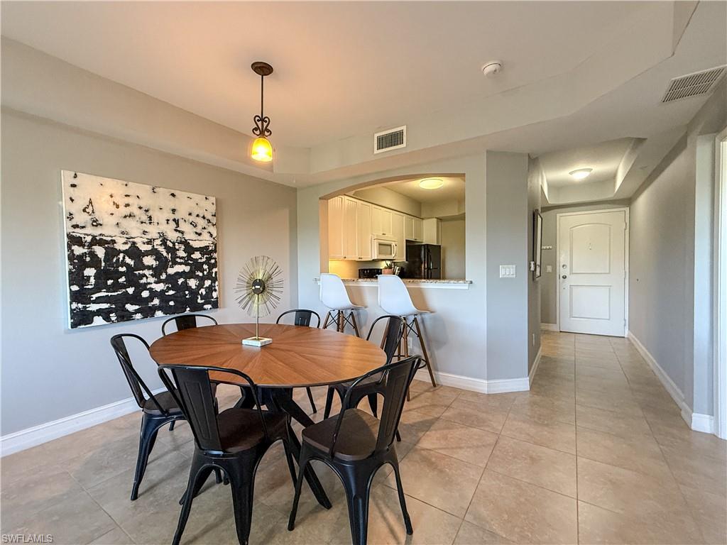 1100 Pine Ridge Road, Unit B405 Naples, FL 34108 - Photo 26 of 43 a dining room with furniture and window
