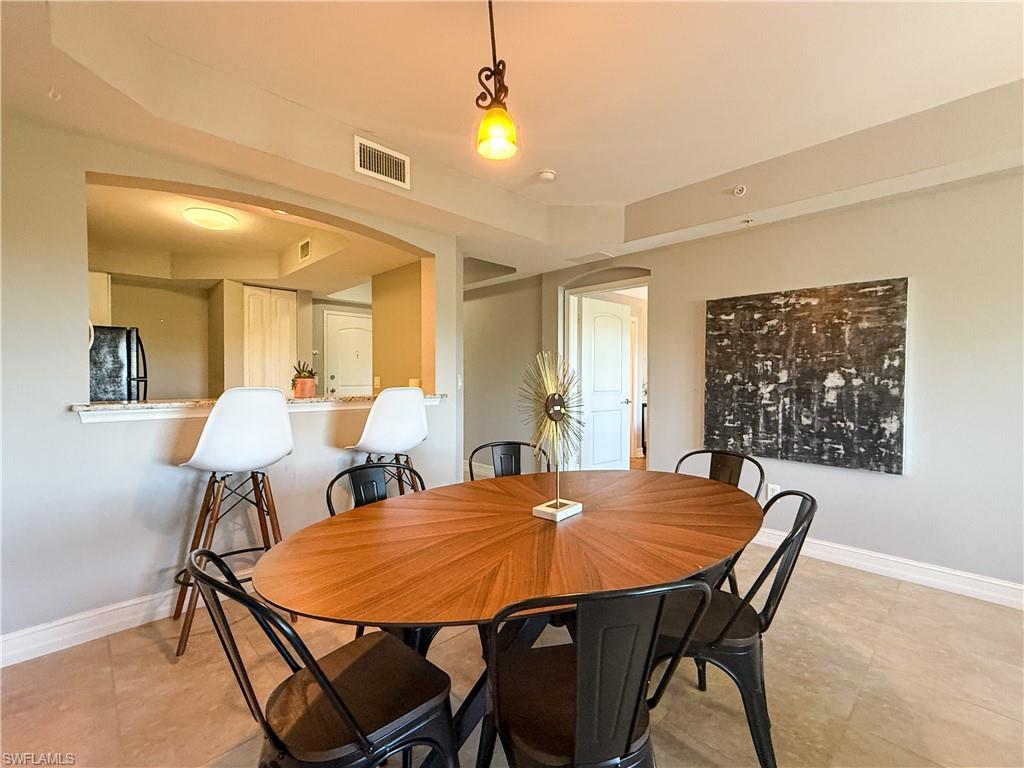 1100 Pine Ridge Road, Unit B405 Naples, FL 34108 - Photo 29 of 43 a view of a dining room with furniture and wooden floor