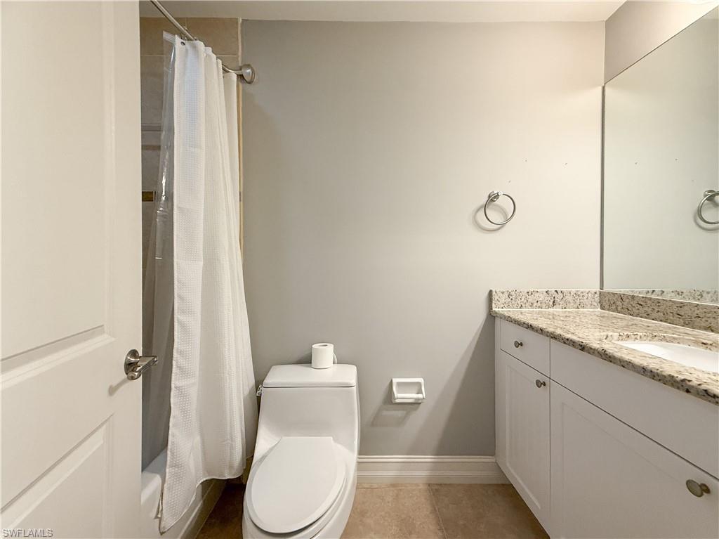 1100 Pine Ridge Road, Unit B405 Naples, FL 34108 - Photo 33 of 43 a bathroom with a granite countertop toilet and a sink