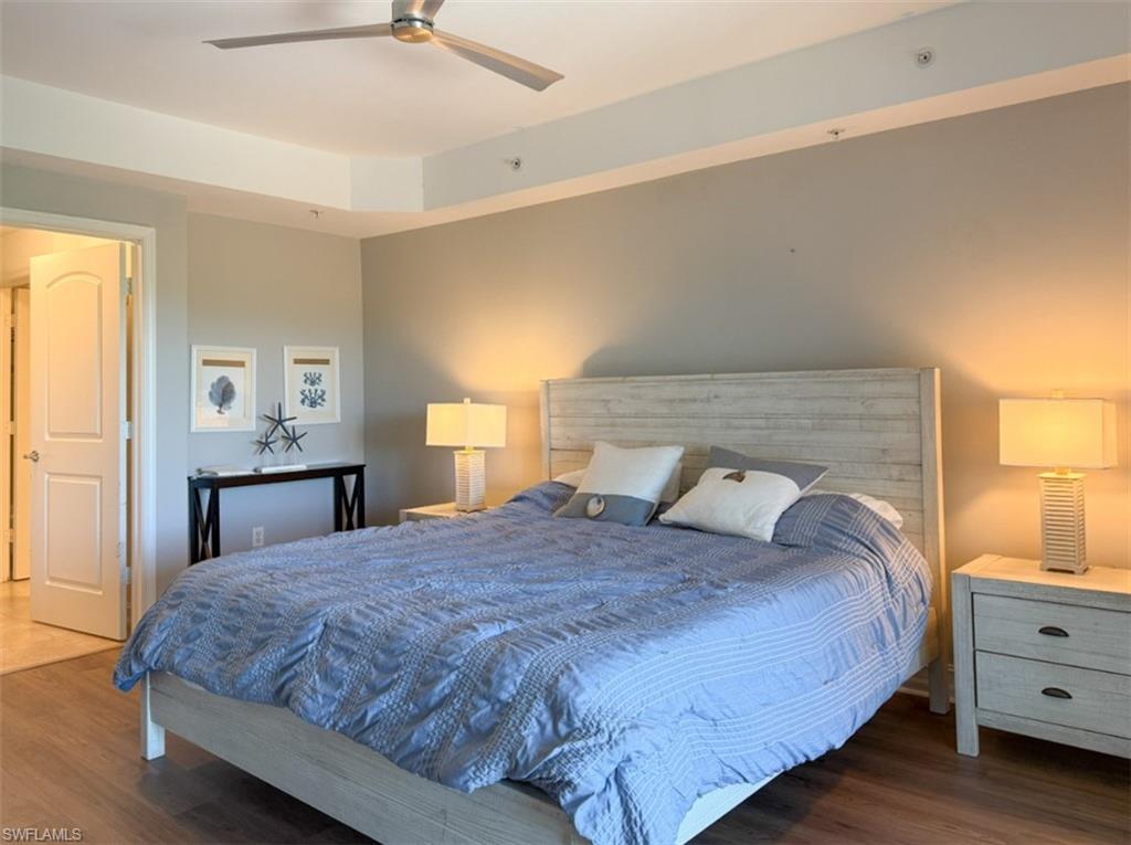 1100 Pine Ridge Road, Unit B405 Naples, FL 34108 - Photo 36 of 43 a bedroom with a bed and a night stand