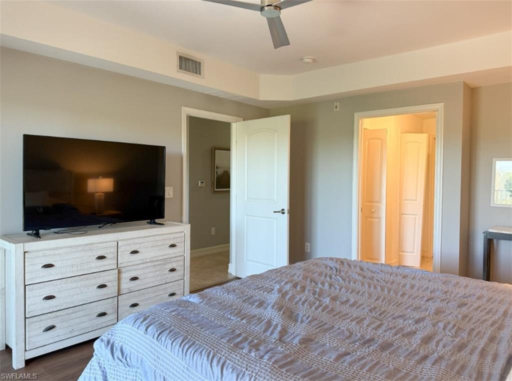 1100 Pine Ridge Road, Unit B405 Naples, FL 34108 - Photo 37 of 43 a bedroom with a bed and flat screen tv