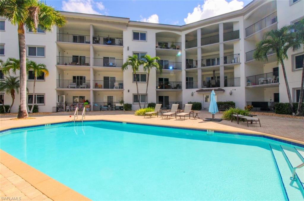 1100 Pine Ridge Road, Unit B405 Naples, FL 34108 - Photo 41 of 43 a view of pool with outdoor seating and yard