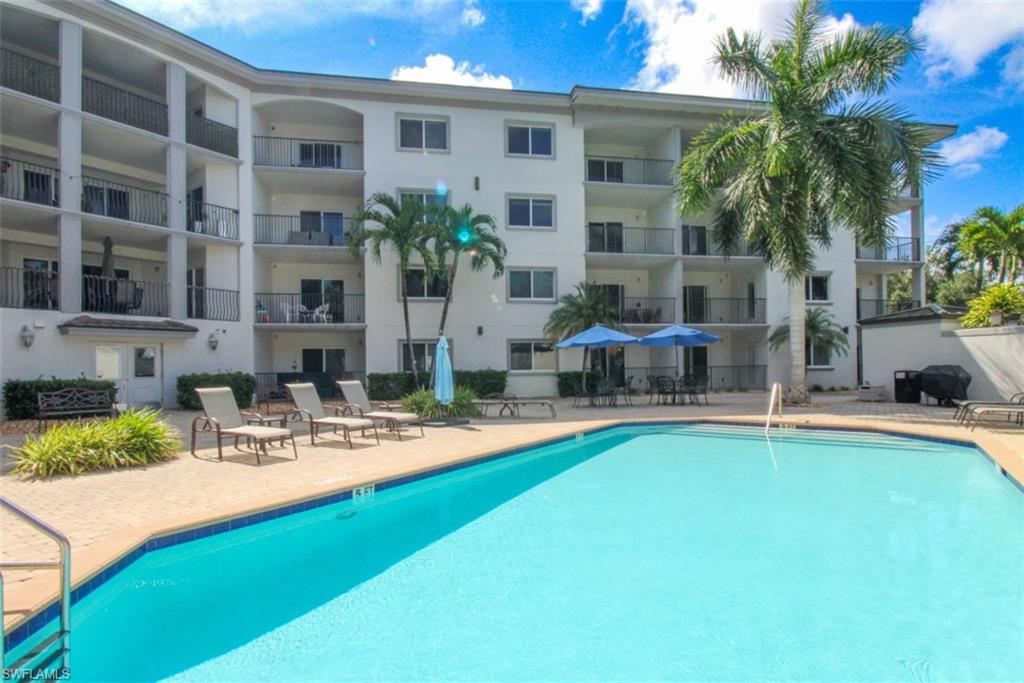 1100 Pine Ridge Road, Unit B405 Naples, FL 34108 - Photo 42 of 43 a view of a house with swimming pool and sitting area
