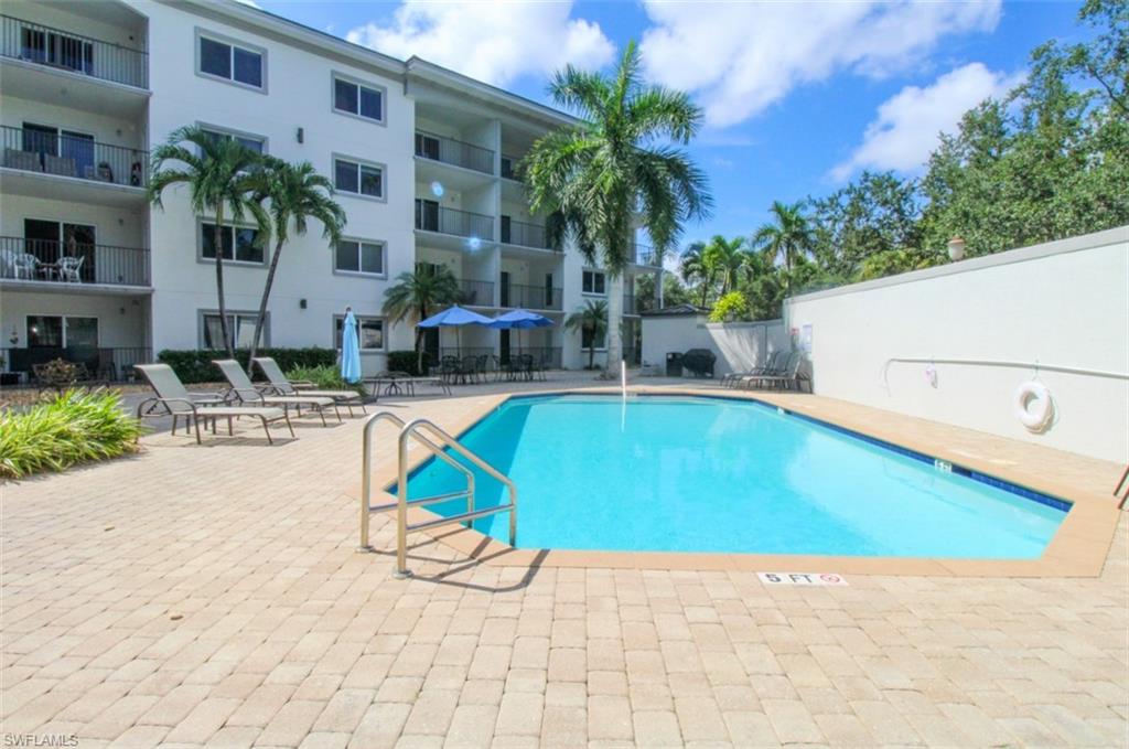 1100 Pine Ridge Road, Unit B405 Naples, FL 34108 - Photo 43 of 43 a view of swimming pool with outdoor seating and plants