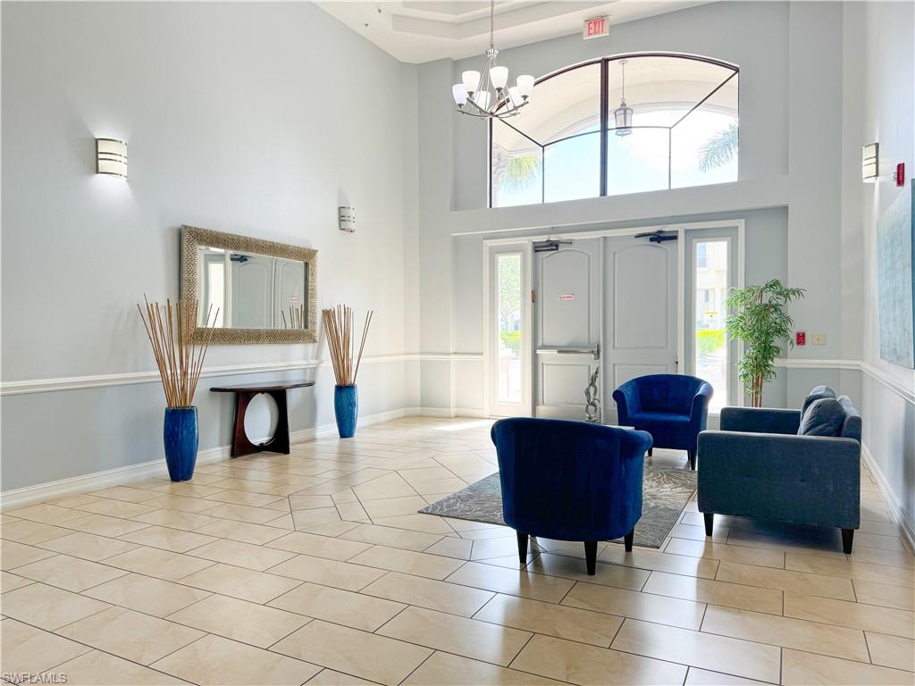 1100 Pine Ridge Road, Unit B405 Naples, FL 34108 - Photo 10 of 43 a living room with furniture and a large window
