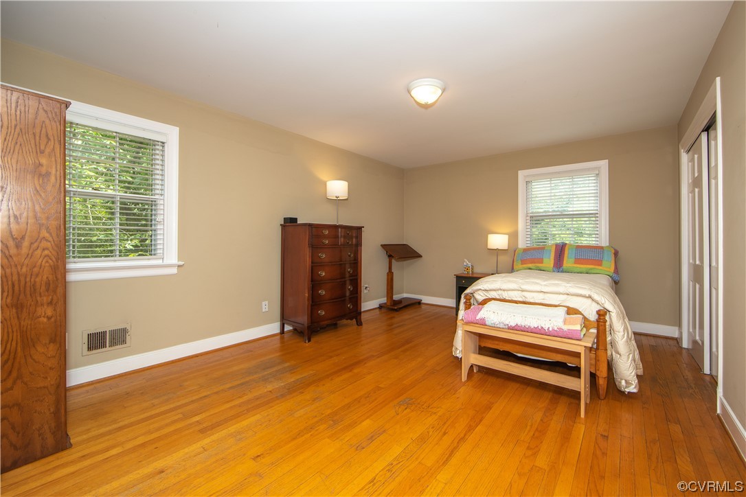 13371 Kingsmill Road Midlothian, VA 23113 - Photo 15 of 43 a bedroom with a bed and wooden floor