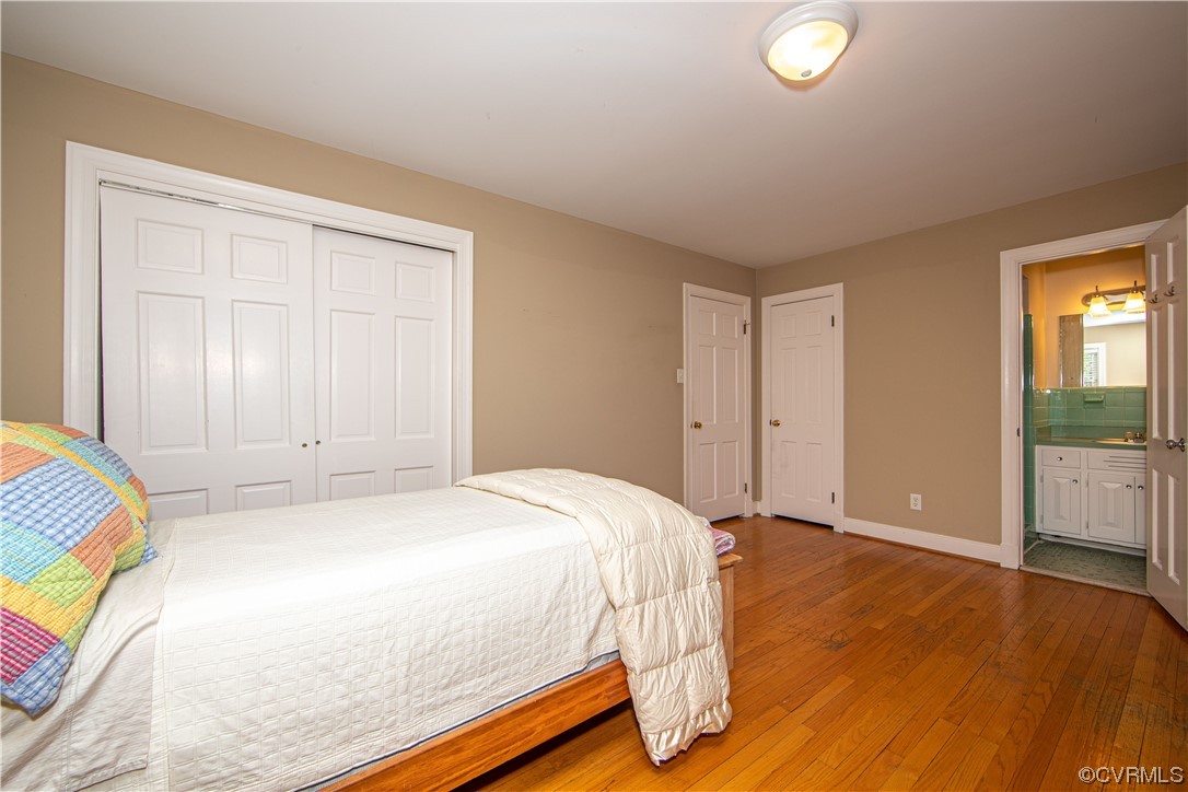 13371 Kingsmill Road Midlothian, VA 23113 - Photo 16 of 43 a bed sitting in a spacious bedroom next to a window and a wooden floor
