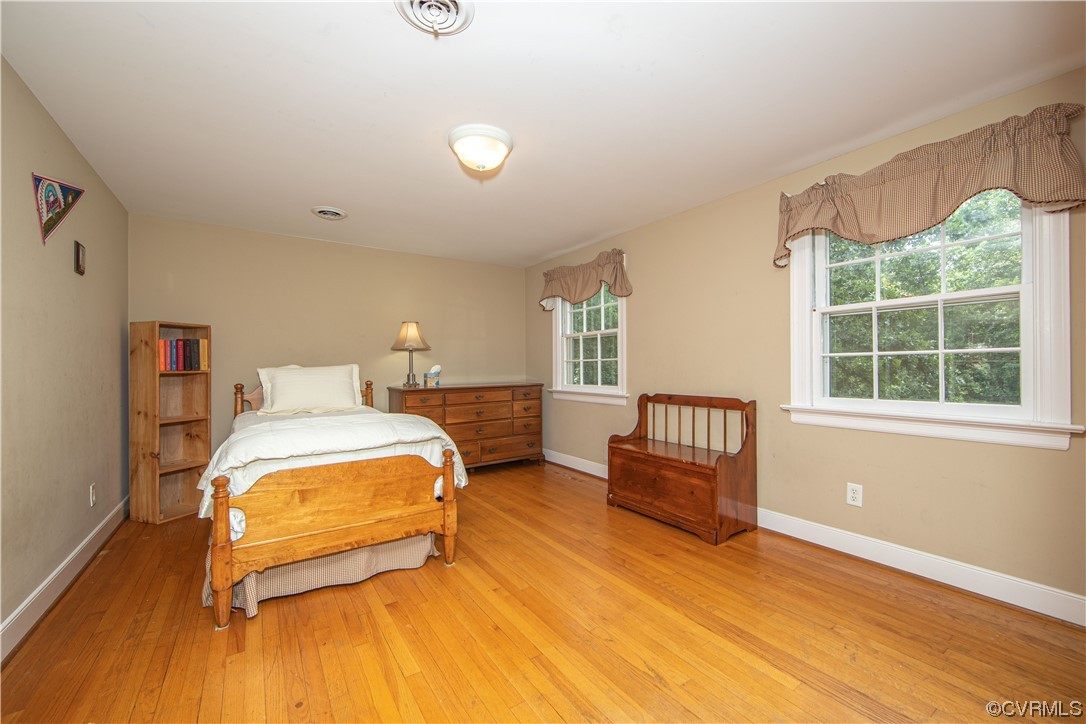 13371 Kingsmill Road Midlothian, VA 23113 - Photo 23 of 43 a bedroom with a bed and wooden floor