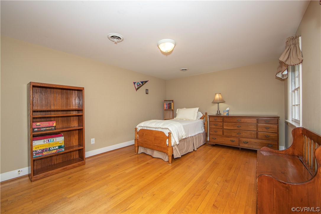 13371 Kingsmill Road Midlothian, VA 23113 - Photo 24 of 43 a bedroom with a bed and a book shelf