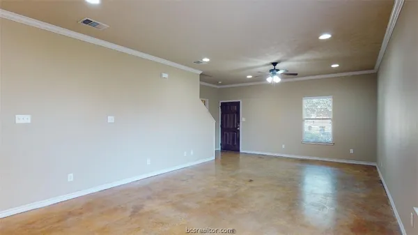 an empty room with windows and closet