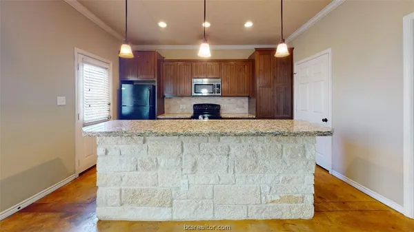 a large kitchen with kitchen island a sink stainless steel appliances and cabinets