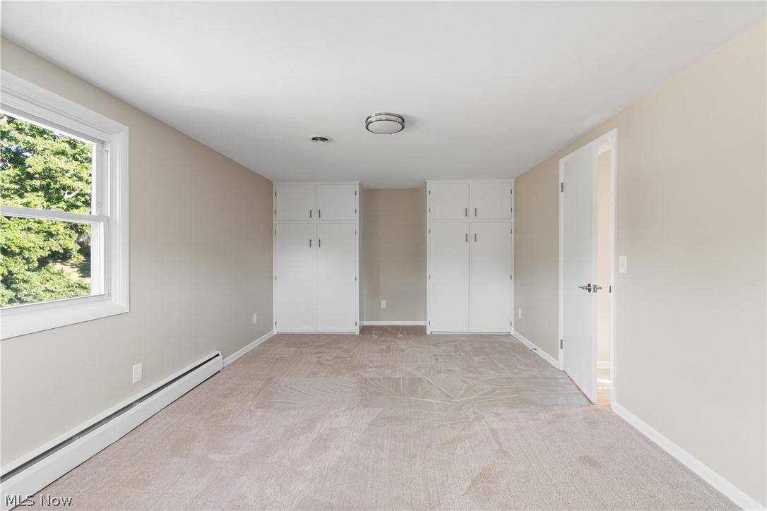 1332 Perry Drive Northwest Canton, OH 44708 - Photo 17 of 32 Unfurnished room featuring light carpet and a baseboard heating unit