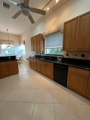 a kitchen with stainless steel appliances kitchen island granite countertop a stove a sink and a microwave