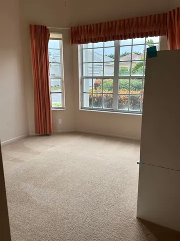 a front view of a house with a yard and flowers