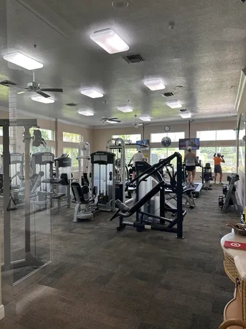 a living room with furniture a large window and a chandelier