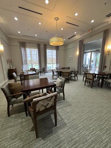 a room with furniture pool table table and a window