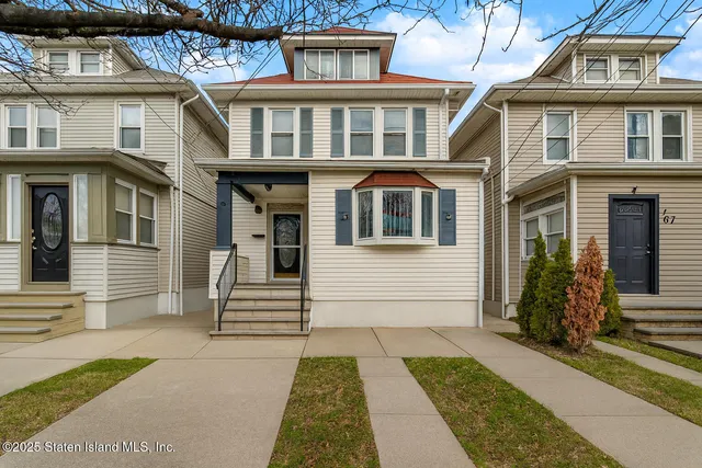 a living room with furniture a flat screen tv and a mirror