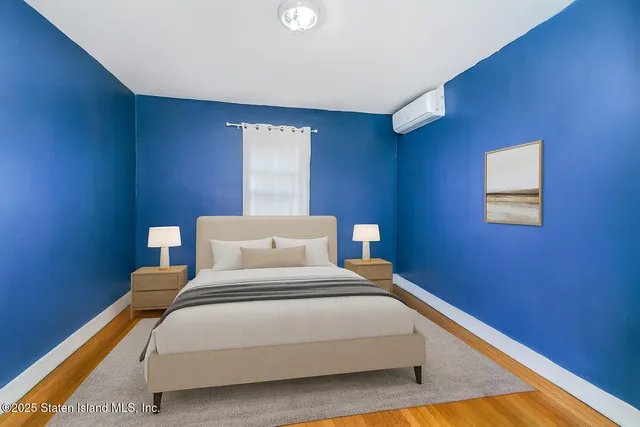 a bedroom with a bed and a lamp with window