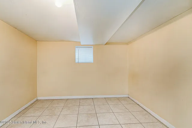 a kitchen with white cabinets and refrigerator