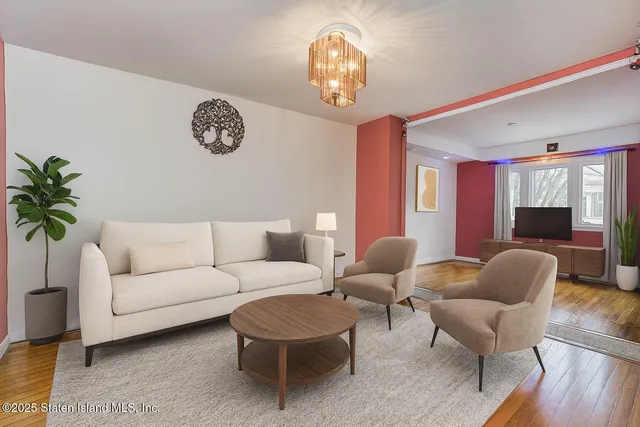 a kitchen with a sink a stove a refrigerator and white cabinets