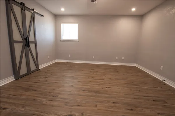 a view of room with window and wooden floor