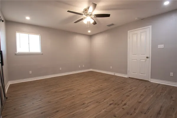 wooden floor in an empty room with a window