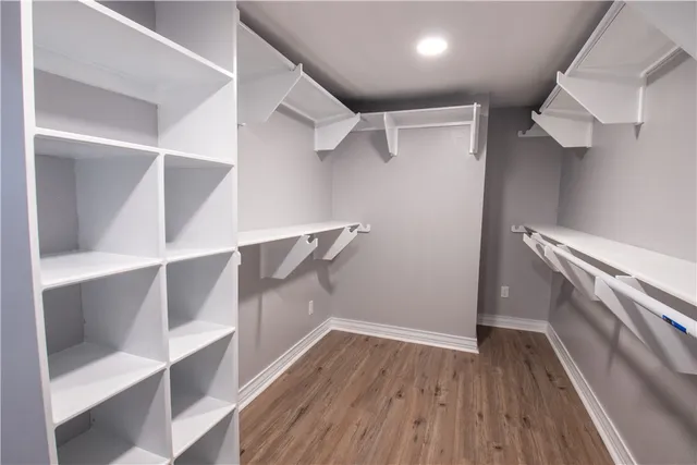 a view of walk in closet with empty racks