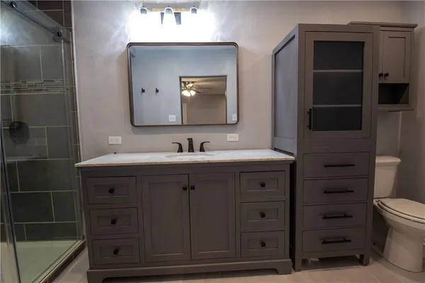 a bathroom with a sink vanity and mirror
