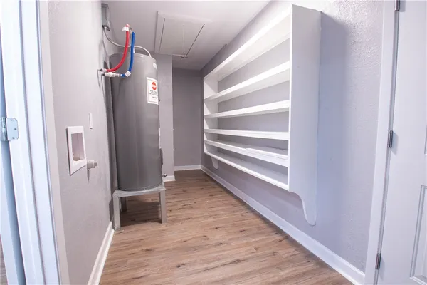 a view of hallway with stairs and wooden floor
