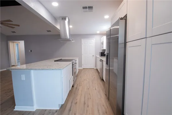 a view of hallway with wooden floor