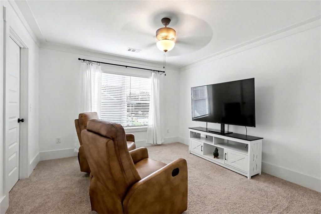 943 Clubside Drive Monroe, GA 30655 - Photo 49 of 93 a living room with furniture and a flat screen tv
