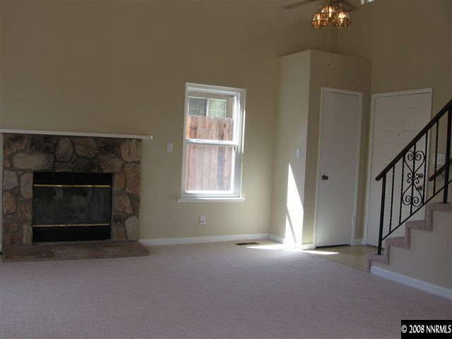 6154 Chesterfield Lane Reno, NV 89523 - Photo 5 of 9 a view of empty room with window and fireplace