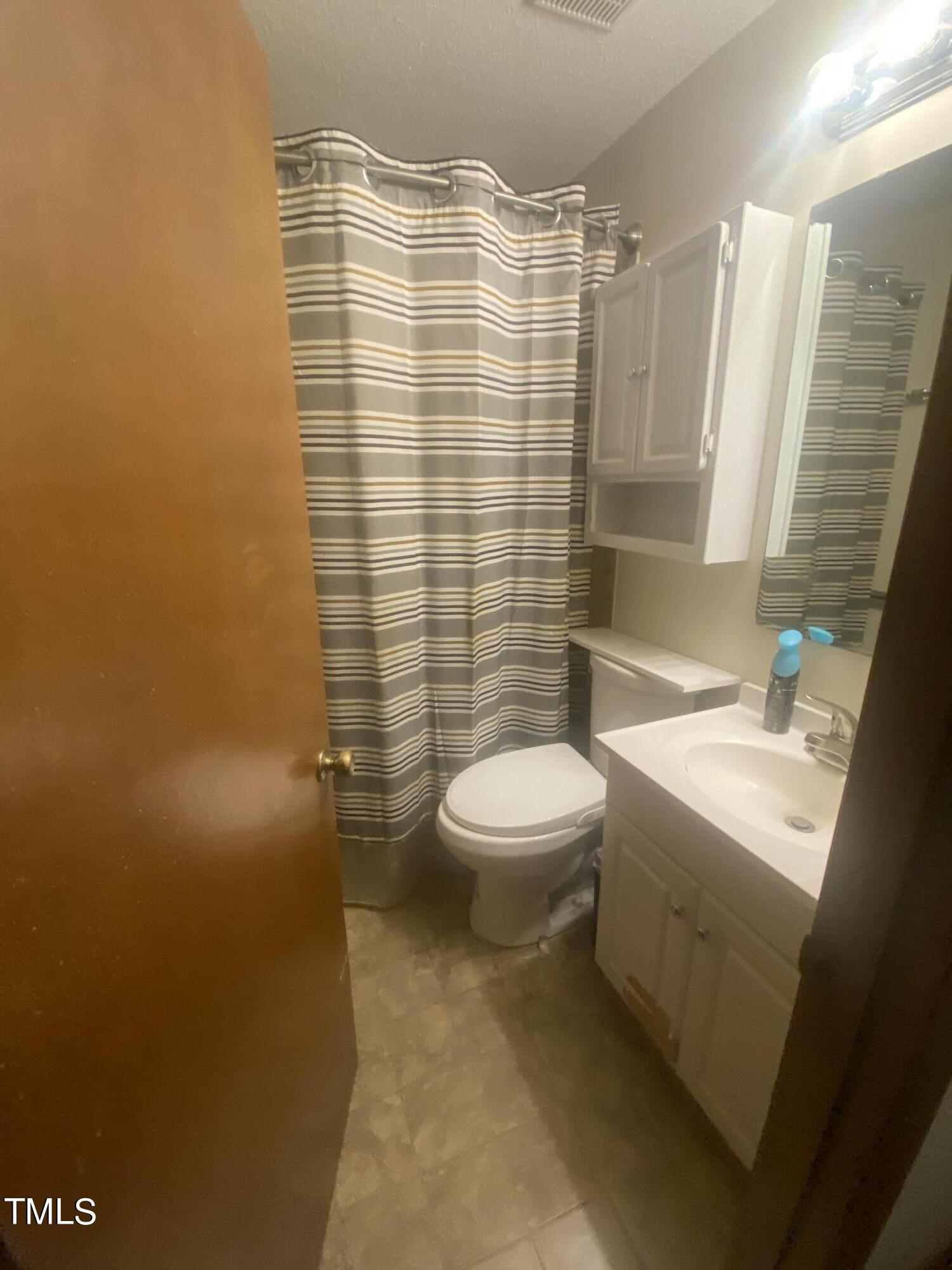 4534 North New Hope Road Raleigh, NC 27604 - Photo 5 of 7 a bathroom with a sink a toilet and shower