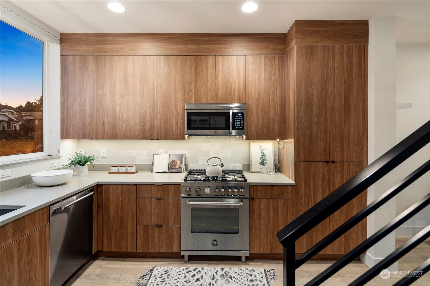 908 North 46th Street, Unit B Seattle, WA 98103 - Photo 21 of 32 a kitchen with stainless steel appliances a stove a sink and a microwave