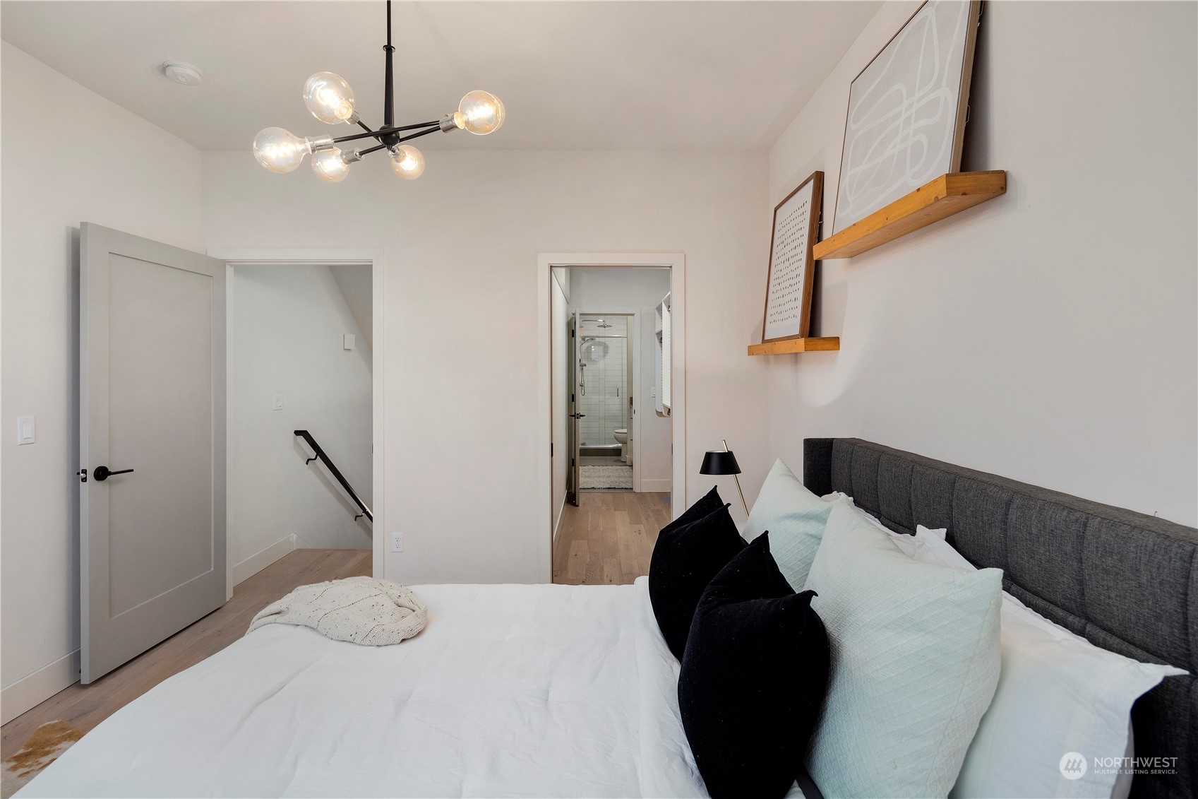 908 North 46th Street, Unit B Seattle, WA 98103 - Photo 24 of 32 a bedroom with a bed and a chandelier