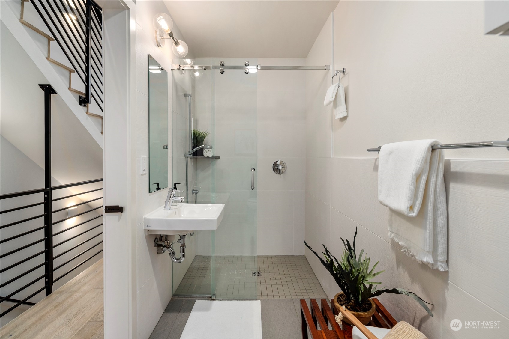 908 North 46th Street, Unit B Seattle, WA 98103 - Photo 6 of 32 a bathroom with a sink a mirror and a shower