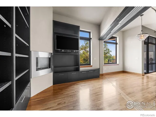 a view of wooden floor and windows in a room