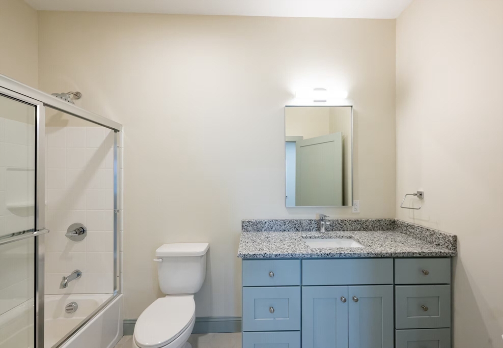 160 Seabury Street, Unit 8 Fall River, MA 02720 - Photo 5 of 13 a bathroom with a granite countertop sink toilet and shower