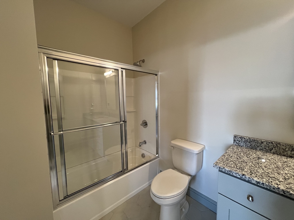 160 Seabury Street, Unit 8 Fall River, MA 02720 - Photo 7 of 13 a bathroom with a granite countertop toilet and a sink