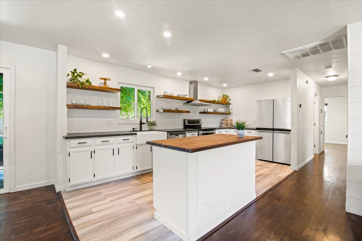 2041 Athens Avenue Redding, CA 96001 - Photo 17 of 36 a kitchen with stainless steel appliances granite countertop a stove and a sink
