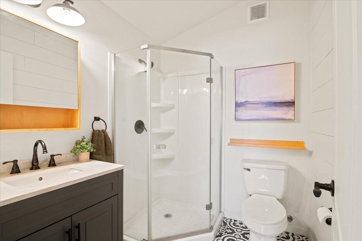 2041 Athens Avenue Redding, CA 96001 - Photo 19 of 36 a bathroom with a shower sink vanity mirror and toilet