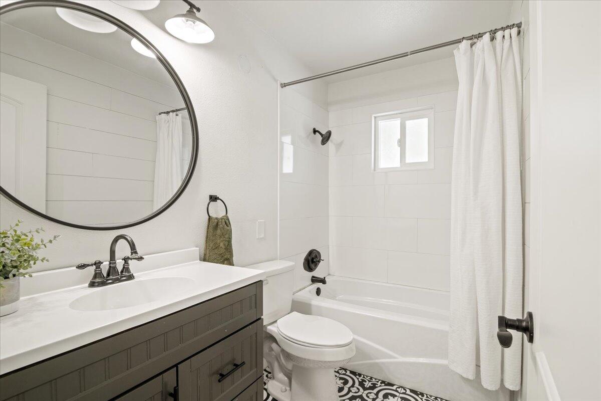 2041 Athens Avenue Redding, CA 96001 - Photo 20 of 36 a bathroom with a sink a toilet and a mirror