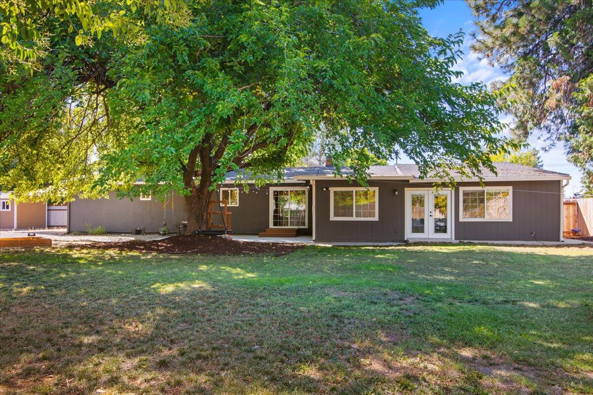 2041 Athens Avenue Redding, CA 96001 - Photo 2 of 36 a view of a yard in front of a house with large trees