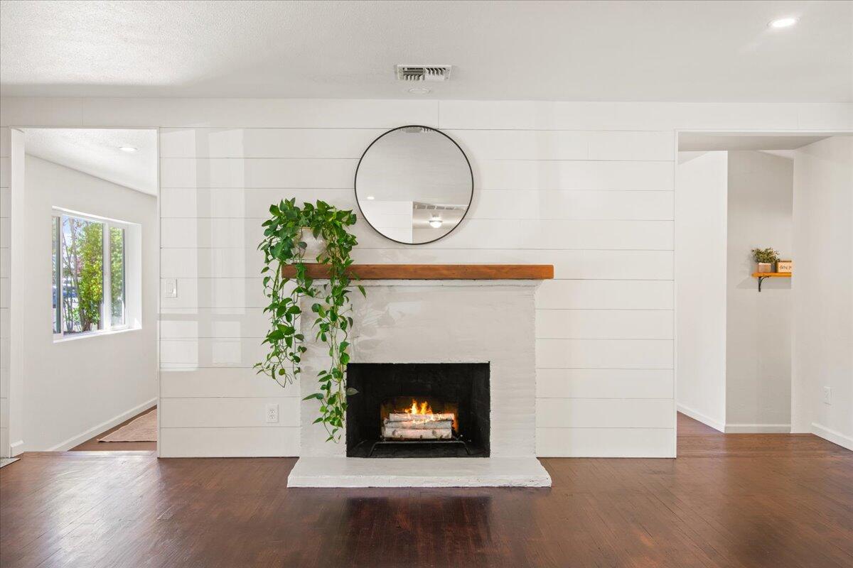 2041 Athens Avenue Redding, CA 96001 - Photo 4 of 36 a living room with a fireplace and a potted plant