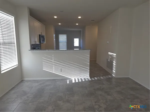a view of a hallway with stairs and a window
