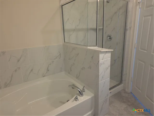 a bathroom with a toilet a sink and bathtub