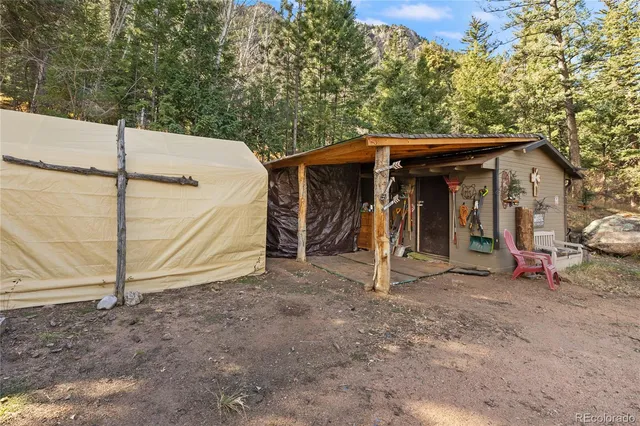 a front view of a house with wooden deck and furniture