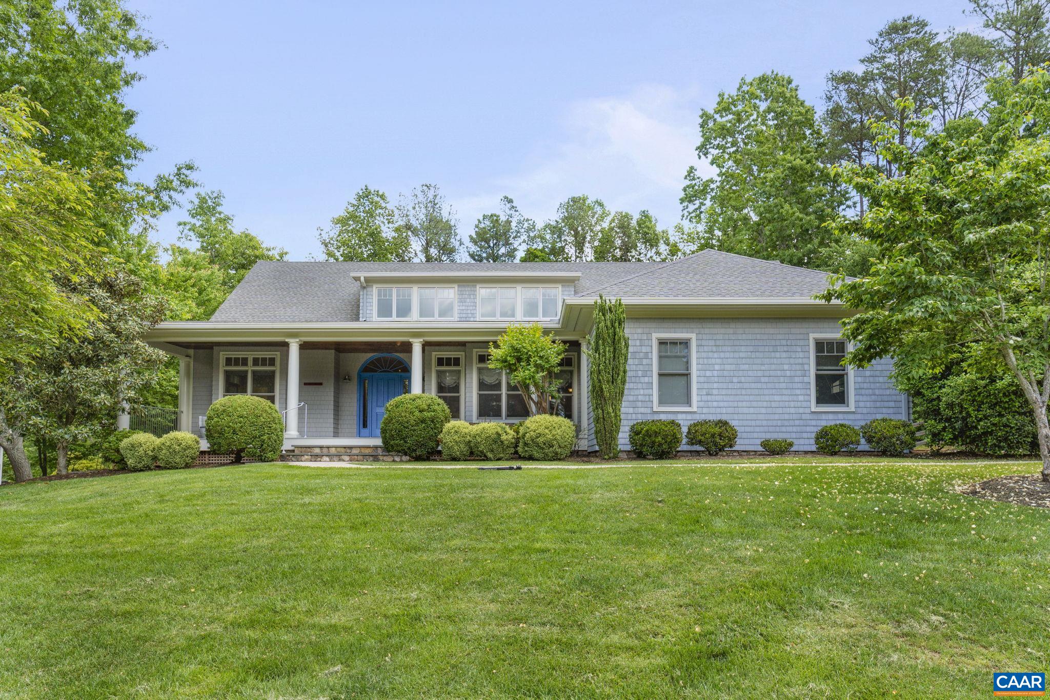 a front view of a house with garden and porch